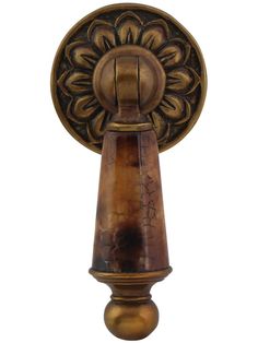 an old fashioned door handle with a flower design on it's end and a round knob