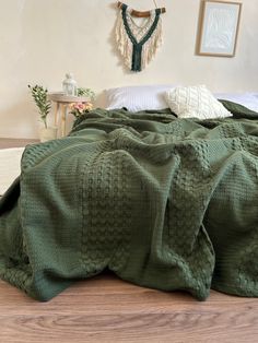 a bed with a green blanket on top of it