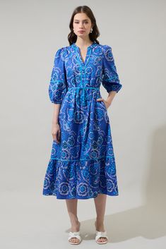 The Kenner Floral Melia Shirt Maxi Dress will be the perfect match to attend all the picnics and brunches. Long sleeves with elastic cuffs frame a split neck like with buttons along. The waist has a belt around and the skirt falls to a tiered hem. Pair it with white heels or any shoes of your choice. - Split neck- Puffed sleeves- Tiered- Pockets- Color: Blue Cream MulSize + Fit - Model is 5'11" and wearing size XS- Measurements taken from size S - Chest: 19 1/4"- Length: 48 1/2" Fabric Self: 100 Infinity Dress Patterns, Shirt Maxi Dress, Shirt Midi Dress, Midi Shift Dress, Infinity Dress, Maxi Shirt Dress, Tiered Midi Dress, White Heels, Flutter Sleeve Top