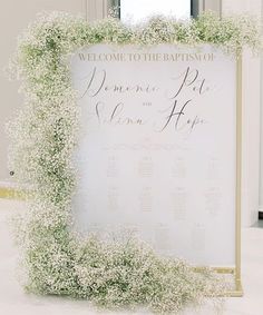 a welcome sign with baby's breath on it