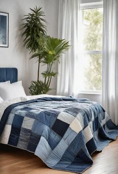 a bedroom with a bed, window and potted plant