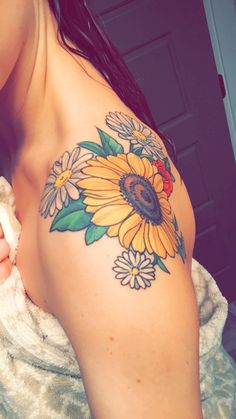 a woman with a sunflower tattoo on her arm