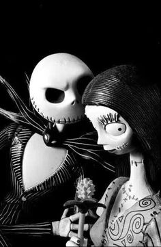 two creepy dolls are standing next to each other with their faces painted black and white