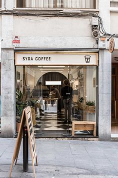 the entrance to a coffee shop on a city street