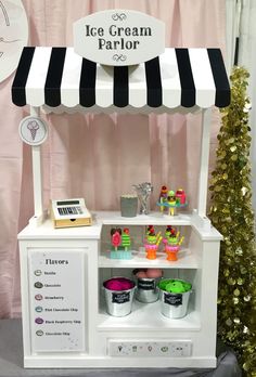 an ice cream parlor is set up in front of a christmas tree