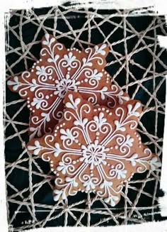 three decorated cookies sitting on top of a net