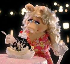 the miss piggy doll is eating her ice cream sundae