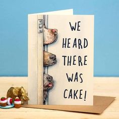 a card with two dogs sticking their heads through a door and the words, we heard there was cake