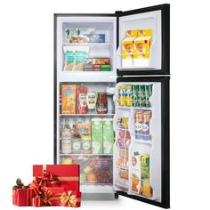 an open refrigerator with its door wide open and wrapped in red ribbon, next to two small presents