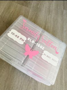 two plastic storage containers with pink butterflies on them