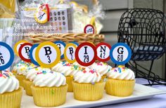 cupcakes with white frosting and colorful decorations