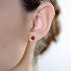 Enhance any wardrobe with these beautiful Ruby earrings. These earrings showcases a genuine natural round 6mm Rubies and white topaz gemstones set in a halo design. Crafted of 10k Rose Gold these earrings make a wonderful addition to your jewelry collection. Classic halo stud earrings feature the July birthstone Ruby 6mm Round Rubies White Topaz Accent (other gemstone colors available) Genuine Natural Gemstones, Solid 10k Rose Gold, Screw-back earring backs Ships from the US in 1-2 business days Small Earrings Gold, Diamond Mangalsutra, Ruby Earrings Studs, Ruby Birthstone, Halo Design, July Birthstone Jewelry, Halo Earrings, Halo Earrings Studs, Ruby Earrings