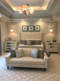 a large bed sitting in the middle of a living room next to a dresser and chair