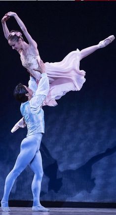 two ballerinas are performing on stage together