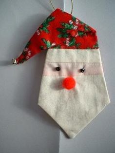 a paper pieced santa ornament with a nose and nose wearing a santa hat