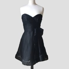 a black dress on a mannequin head stand