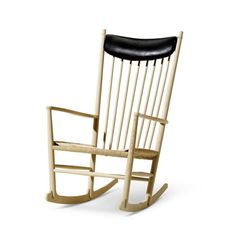 a wooden rocking chair with black leather seat and backrest on an isolated white background