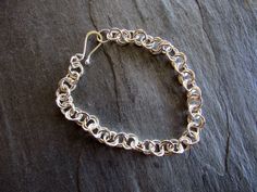 "Here is a handmade chain maille bracelet made of sterling silver. I formed and cut many, many rings of sterling silver 18 gauge round wire and connected them in overlapping pairs. The bracelet is supple and shiny. The clasp is a handmade hook. It looks great alone or with others. 8\" long. I can shorten it if you wish. a perfect gift." Chainmaille Bracelet, Infinity Bracelet, Chain Link Bracelet, Chain Link, Handmade Silver, Bracelet Making, Silver Bracelet, Jewelry Bracelets, Bracelet