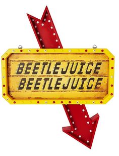 a sign that says beetlejuice with an arrow pointing to the right and down