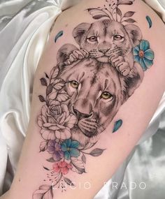 a woman's arm with a lion and flowers on it