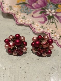 These vintage burgundy red clip on earrings will be sure to dazzle!  They are lightweight and are about an inch wide.  One is missing a little of the gold pieces that covers the bead, as seen in the video, however it is a minor flaw and does not stand out. Red Christmas Earrings For Formal Occasions, Red Earrings For Christmas Formal Events, Red Earrings For Christmas Formal Occasion, Red Clip-on Earrings For Party, Vintage Jewelry For Holiday Parties, Vintage Holiday Jewelry For Party, Vintage Holiday Party Jewelry, Holiday Party Vintage Jewelry, Red Vintage Earrings For Valentine's Day