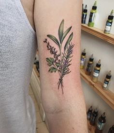 a woman's arm with a flower tattoo on the left side of her arm