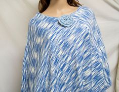 Knit Poncho,Poncho top, Blue, White, Sweater, Flower Pin Lovely, blue and white colored poncho with removable blue flower pin Measures: Bust: 54'' all the way around Length from neck to bottom: 30'' 100% acrylic Excellent condition A305 Knit Poncho,Poncho top, Blue, White, Sweater, Flower Pin Casual Blue Poncho For Spring, Blue Poncho For Beach In Spring, Blue Bohemian Poncho For Spring, Spring Blue Bohemian Poncho, Poncho Top, Knit Poncho, Perfect Together, Poncho Tops, Womens Sweaters