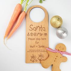 a wooden cutting board with a christmas ornament and carrots next to it