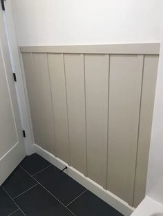 a white toilet sitting in a bathroom next to a wall