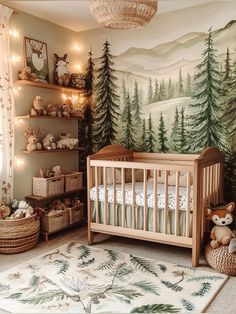 a baby's room with a forest mural on the wall