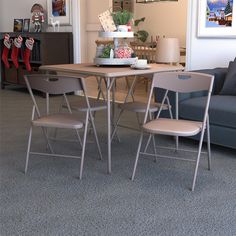 a living room filled with furniture and a wooden dining table surrounded by grey carpeted flooring