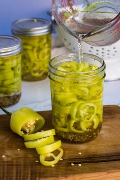 pickled jalapenos are being poured into a jar