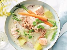 a white bowl filled with meat and vegetables