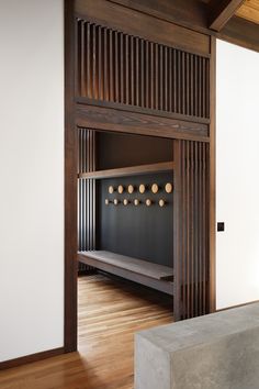 an empty room with wood paneling and white walls