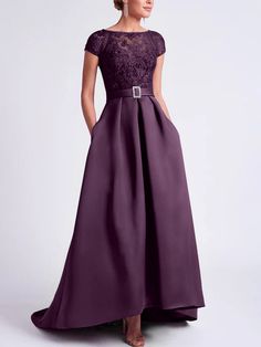 a woman in a long purple dress with an open back and lace detailing on the top