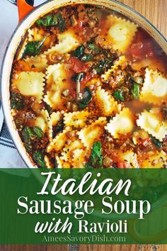 italian sausage soup with ravioli and spinach in a skillet on a wooden table