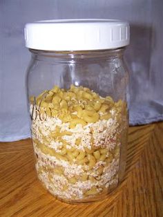 a jar filled with cereal sitting on top of a wooden table