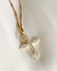 The Luxe Cross Necklace adds that perfect touch of brilliance to your look, and layers perfectly with other gold necklaces. Cross pendant is 14K gold plated silver with Cubic Zirconia, on rolo gold filled chain. Pendant: 19x25mm & 2.5mm thick. All items come in a gift box ready to gift. To see more please visit  https://www.etsy.com/shop/BijouLimon Bijou Limon jewelry collections present a romantic French spin on the latest jewelry trends. Based on the US West Coast but French at heart, Bijou Li Dazzling Gold Necklace, Elegant 14k Gold-filled Cross Pendant Necklace, Spiritual Gold Crystal Necklaces For Layering, Dazzling Gold Pendant Necklace, Elegant Gold Crystal Necklaces For Layering, Elegant Gold Crystal Necklace For Layering, Dazzling Gold Clavicle Necklace, Dazzling Gold Jewelry With Delicate Chain, Dazzling Gold Clavicle Chain Necklace