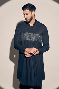 Black kurta with placed cutdana embroidered detail. Comes with pant.
Components: 2
Pattern: Embroidered
Type Of Work: Cutdana
Neckline: Mandarin Collar
Sleeve Type: Full
Fabric: Twill cotton 
Color: Black
Other Details: 
Straight silhouette
Closure: Kurta: Front closure
Occasion: Sangeet,Cocktail - Aza Fashions Black Kurta, Men Kurta, Party Wear Indian Dresses, Kurta With Pants, Mandarin Collar, Aza Fashion, Indian Dresses, Sleeve Type, Party Wear