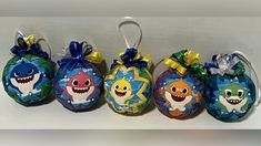 five ornaments with cartoon characters on them