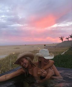 two women in a hot tub at sunset