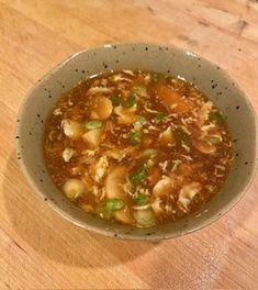 a bowl of soup on a wooden table