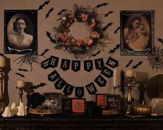 a mantle with halloween decorations and pictures on it