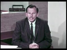 a man in a suit and tie sitting at a desk