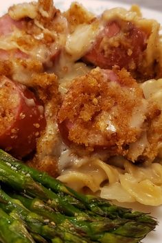 some pasta and asparagus on a white plate