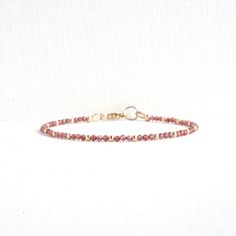 Red Garnet Dainty Bracelet Finished with a lobster claw clasp. *BRACELET LENGTH- 6.5 - 8.0 Inches* * MATERIALS & DIMENSIONS *  * Red Garnet Beads: about 2.0 mm - Grade AAA  * Gold Filled or Sterling Silver Beads: about 2.0 mm * Silver or Gold Filled Findings * Premium Strong Flexible Beading Wire *Arrives in a gift box* Choose Your Bracelet Length Use a tape measure. Wrap the tape measure around the wrist on which you plan to wear your bracelet. Make a note of the number at the point where the t Dainty Red Beaded Bracelets For Everyday, Adjustable Burgundy Bracelet, Adjustable Burgundy Bracelets, Adjustable Red Jewelry With Lobster Clasp, Adjustable Burgundy Round Bead Bracelets, Black Onyx Bracelet, Garnet Bracelet, Dainty Bracelet, Clasp Bracelet