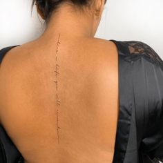 the back of a woman's neck with an inscription on her left upper arm