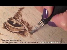 a person is drawing something on wood with a crayon pen and some ink