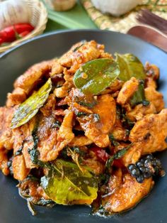 a blue plate topped with meat and vegetables