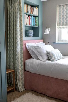 a bedroom with a bed, bookshelf and window